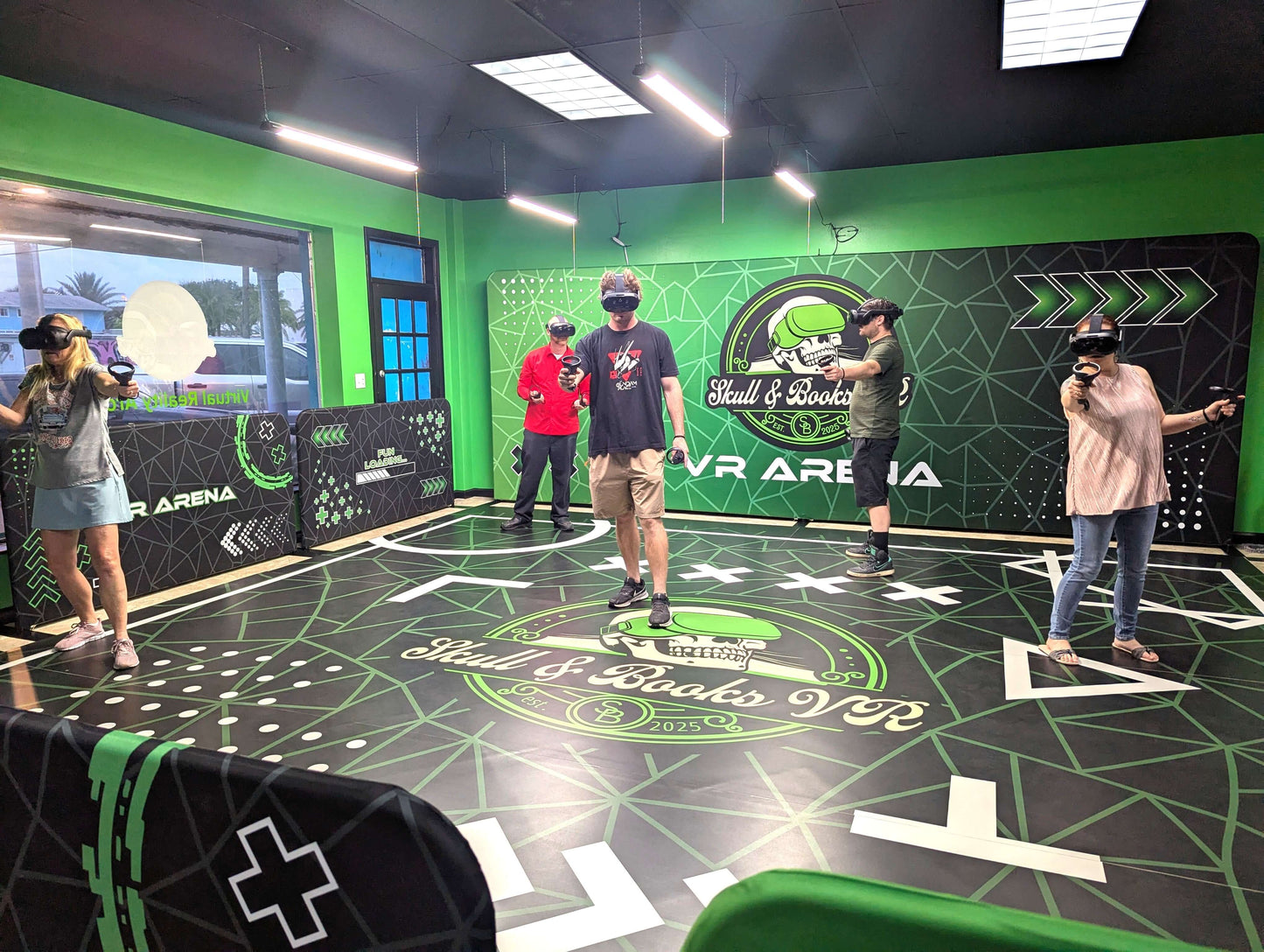 Group of five adults enjoying immersive virtual reality arcade at Skull & Books VR in Cocoa Beach